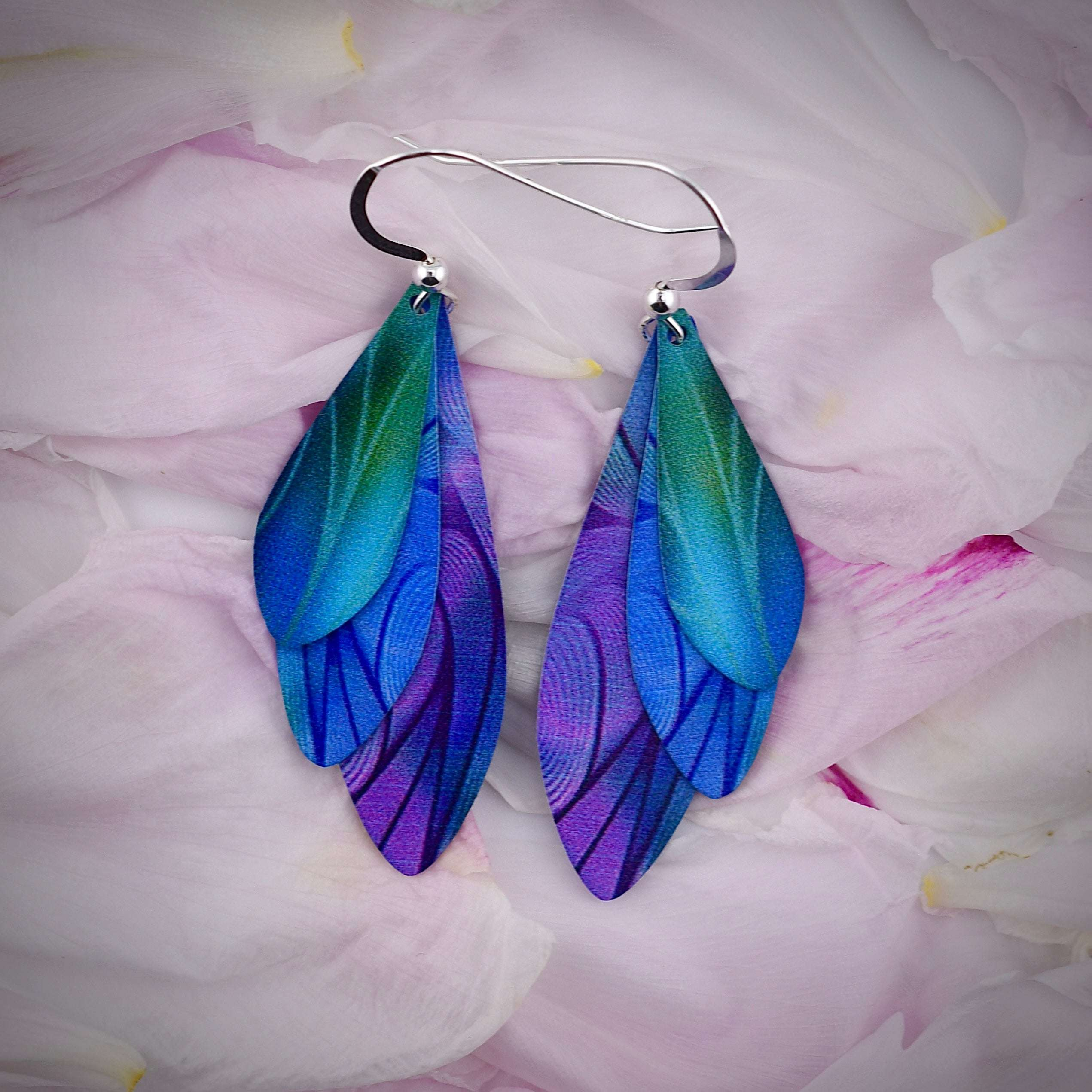 Layered feather earrings in iridescent blue, green, and purple, made from stainless steel with sterling silver ear wires.