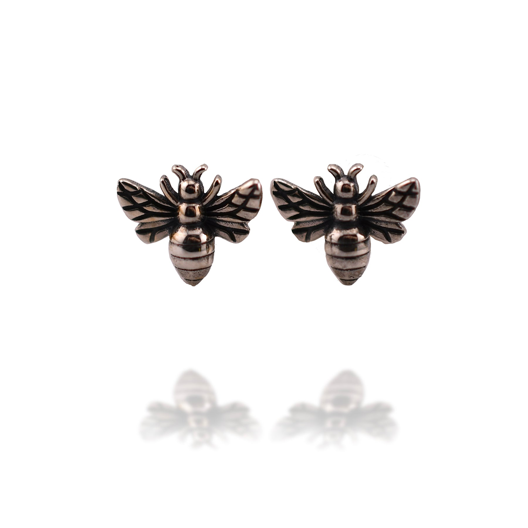 Pair of recycled sterling silver post earrings shaped like tiny bees, with detailed wings and bodies.